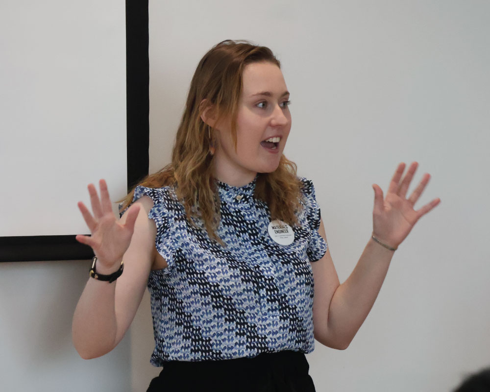 smiling professor with her hands up